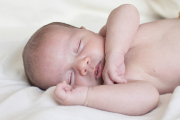 newborn sleeping in bed