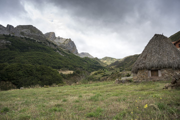Fototapeta na wymiar Valley of the River Trabanco, La Peral, in Somiedo Nature Reserve. It is located in the central area of the Cantabrian Mountains in the Principality of Asturias in northern Spain