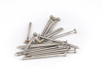 Bunch of inox nails close up on a white background