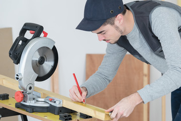 carpenter at work carefully looking at the plans