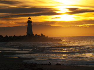 Lighthouse in an Electric Sunrise with Waves