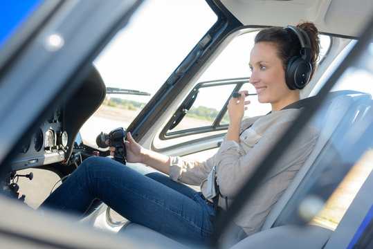 portrait of young beautiful woman pilot in a airplane