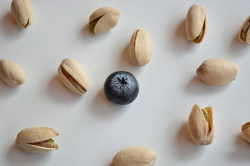 Pistashio nuts and one blueberry