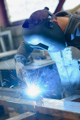 welder working in manufacture production plant