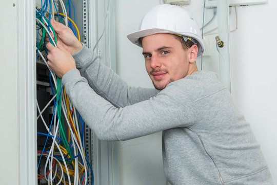 A Man Working On Electric Wire