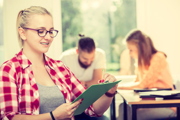 Fototapeta premium Student girl in front of her mates in classroom
