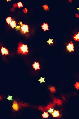 Christmas, New Year background with beautiful stars bokeh of colorful garland lights