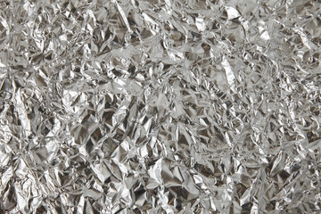 shiny crumpled uneven surface silver foil background