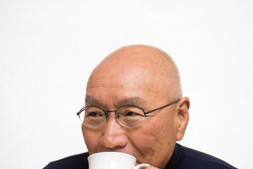 コーヒーを笑顔で飲むシニア