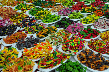 Mixed plastic food magnets displayed on white plates
