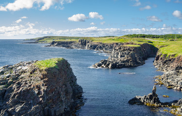 Rear view from road to Cape Bonavista lighthouse station, Newfoundland,  Panoramic vista, bright blue late summer morning over Atlantic Canada.