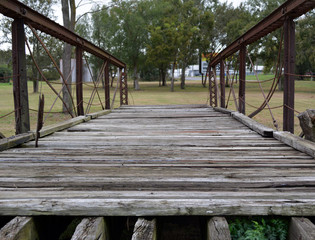 Fototapeta premium Bridge in the grass/Old Wood and Steel bridge