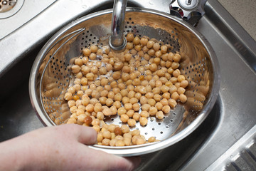 Washing chickpeas under running water
