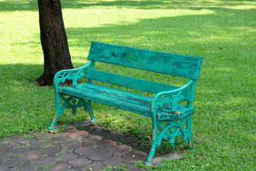 Old wooden green bench in the garden park
