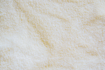fiber fabric texture background in cream color tone. fabric uneven