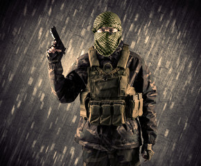 Armed terrorist man with mask on rainy background