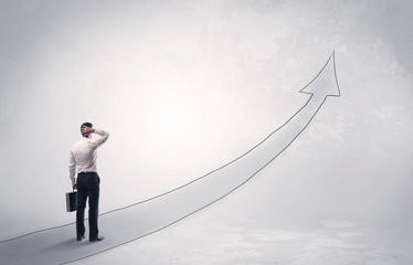 Obraz premium Business man standing on drawn arrow