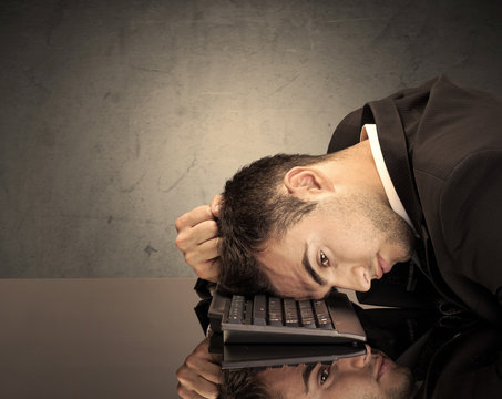 Frustrated businessman's head on keyboard