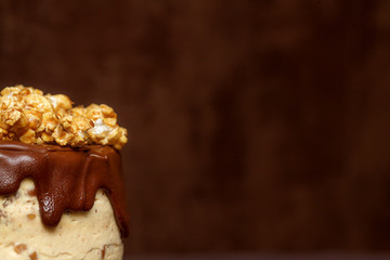 Chocolate cake with caramel and popcorn, close up