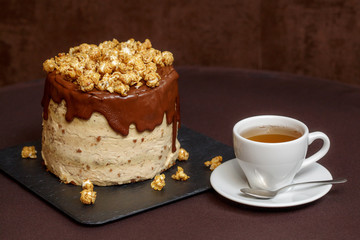 Chocolate cake with caramel and popcorn, close up