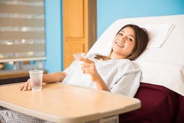 Cute Hispanic woman taking some medicine