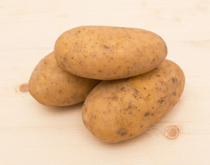 Fresh potatoes on a wooden background