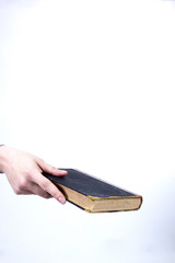 Hand holds an old book