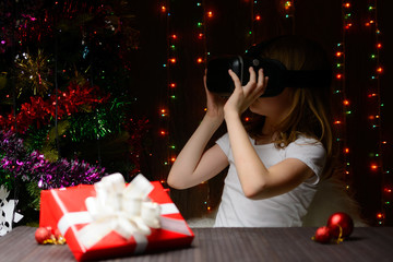 The girl received a Christmas present virtual glasses