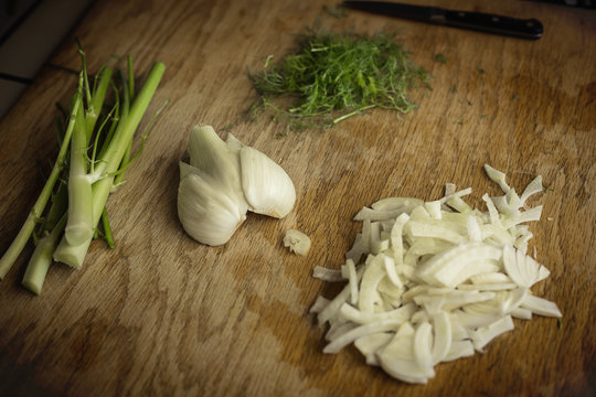 Close up view of a chopped fennel on a cutting board in a kitchen