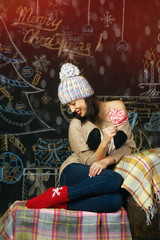 Young woman on a Christmas background . Merry Christmas