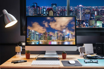 Graphic Designer Workspace with city night view