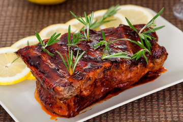 Slow cooked pork ribs with rosemary. Horizontal shot.