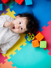 Asian baby girl playing stacking cups