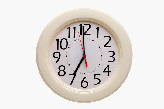 Analog wall clock showing 7:00 o'clock