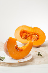 raw chopped pumpkin on white wooden background