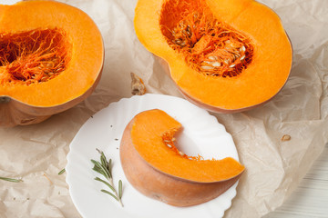 raw chopped pumpkin on white wooden background