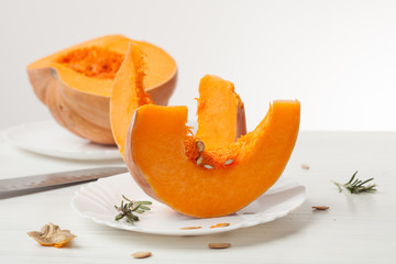 raw chopped pumpkin on white wooden background