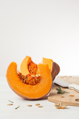 raw chopped pumpkin on white wooden background