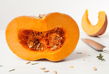 raw chopped pumpkin on white wooden background