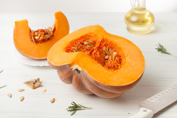 raw chopped pumpkin on white wooden background