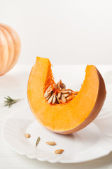 raw chopped pumpkin on white wooden background
