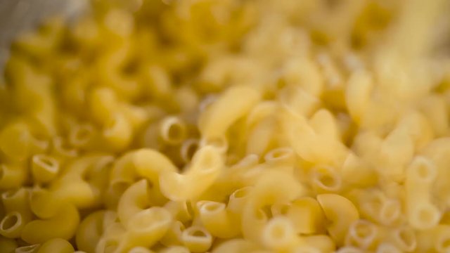 Dry Italian pasta pouring in a heap