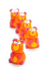 Row of clay toys (bears). Isolated on white background