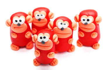 Naklejka premium Group of clay toys (monkeys). Isolated on white background