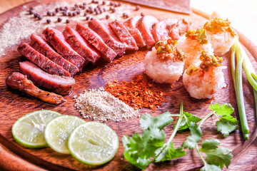 Thai-Style Grilled Steak (Neua Yang) served with sticky rice and chili sauce.