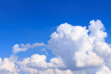 Naklejka premium Blue sky background with white clouds and rain clouds. The vast blue sky and clouds sky on sunny day. White fluffy clouds in the blue sky.