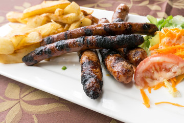 Grilled sausage served with french fries