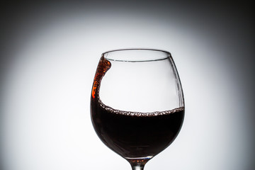 Stream of wine being pouring into a glass.