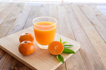 Orange juice on wooden background