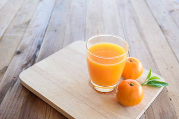 Orange juice on wooden background